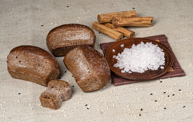 freshly baked bread on a linen tablecloth with salt on the kitchen table.