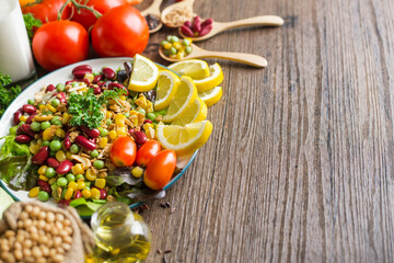 Healthy food background ,fruits and vegetables with salad bowl on wooden table.