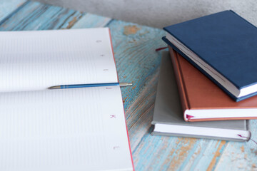 Workplace with notebooks and pen. Lie on the table.