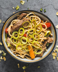 Overview of oriental noodles with vegetables, meat and soy sauce