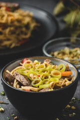 Oriental noodles with vegetables, meat and soy sauce
