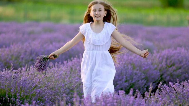 a girl in a white dress runs through a lavender field