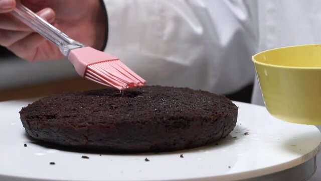 spreading rose water on cake making prosess  close up