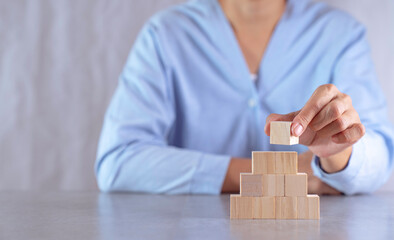 hand stack woods block step on table. business development concept.copy space.