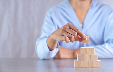 hand stack woods block step on table. business development concept.copy space.