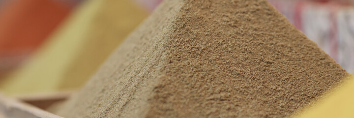 Spices are pouring in shape of pyramid closeup