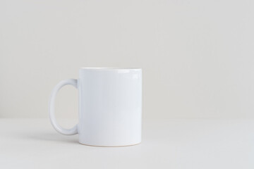 Single white mug on light gray background, mockup