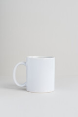 Single white mug on light gray background, mockup