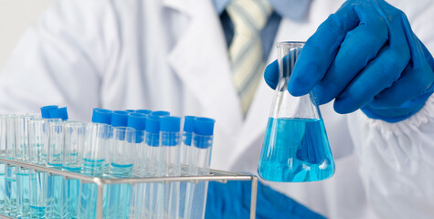 Doctor holding test tube with sample for analysis in laboratory, closeup
