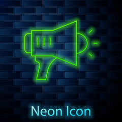 Glowing neon line Megaphone icon isolated on brick wall background. Speaker sign. Vector