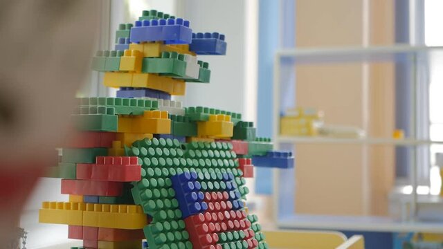 The robot is assembled from the details of the constructor in the children's room on the shelf. The result of the child's labor. Close-up.