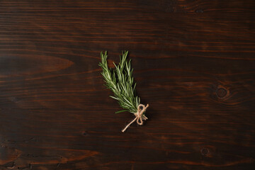 Fresh rosemary herb on a wooden board. Top view rosemary with copy space.