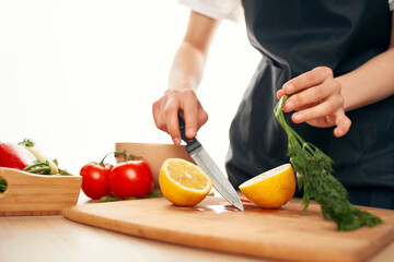 slicing lemon on the board with a knife kitchen cooking ingredients