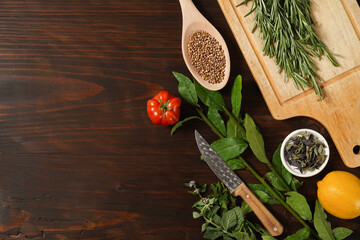 Assorted spices with fresh herbs on a wooden background. Natural food additives. Aromatic herbs and spices from garden, healthy cooking concept. Flat lay, top view