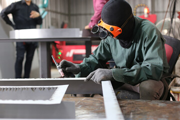 Welder working at the factory. Welding process. Welder occupation