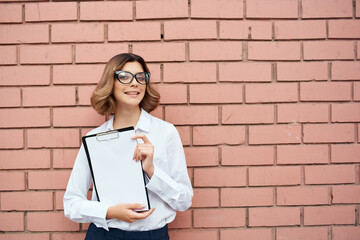 woman in white shirt documents work professional