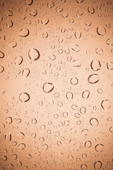 water drops on Brown glass background.