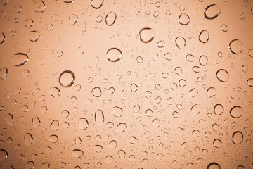 water drops on Brown glass background.