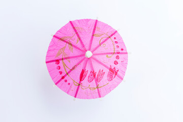 Design pink paper umbrella isolate on white background,  cocktail decorate item