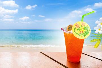 Tropical fruit ice tea on the beach, summer drink