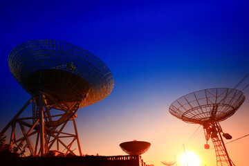 The silhouette of a radio telescope observatory