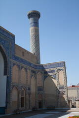 A wall with mosaics and a minaret in the Gur Emir Amir Temur mausoleum in Samarkand in Uzbekitsan. 29.04.2019
