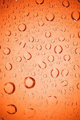 Bubble water on red glass background.