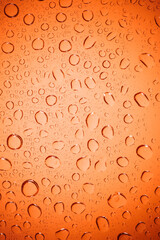 Bubble water on red glass background.
