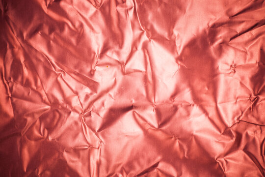 Crumpled Red Aluminum Foil Background.