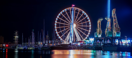 Szczecin, Poland, July 2021: Night amusement park, beautiful illuminations photographed in motion