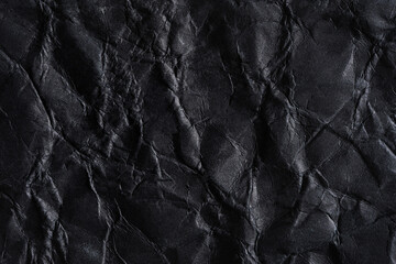 Paper black wrinkled background. Abstract background made of crumpled paper for design, texts, covers, web banners, logos. A mockup in a solid color, a textured template, a form for writing with folds