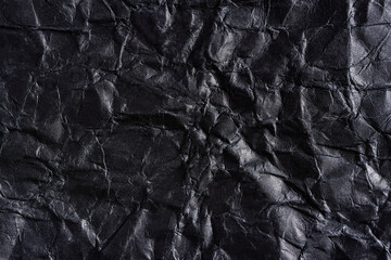 Paper black wrinkled background. Abstract background made of crumpled paper for design, texts, covers, web banners, logos. A mockup in a solid color, a textured template, a form for writing with folds