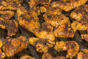 many golden grilled tasty chicken wings on a pan