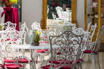 white chairs and tables with red pad in an elegant room