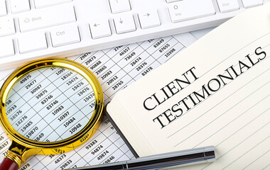 CLIENT TESTIMONIALS text on notebook with chart, magnifier,keyboard and pen