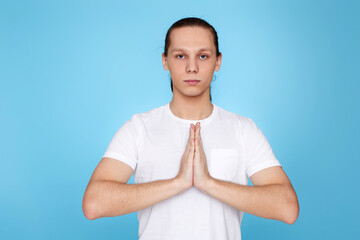 calm man holding hands in yoga gesture