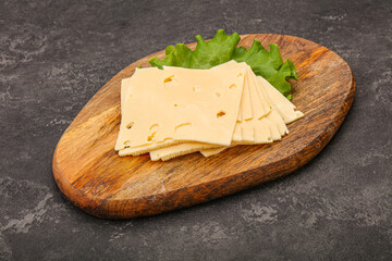 Sliced yellow cheese over board