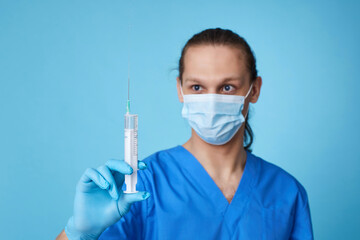 young man wearing doctor uniform holding syringe