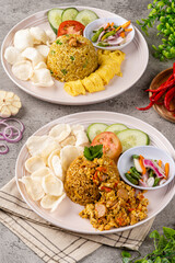 Fried rice is a dish of cooked rice that has been stir-fried in a wok or a frying pan and is usually mixed with other ingredients such as eggs, vegetables, seafood, or meat.