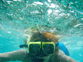 woman underwater with snorkeling goggles