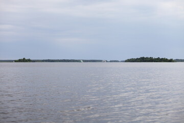 Volga river beautiful panoramic view from water on floating passenger ship and cargo vessel at summer day commercial navigation traffic