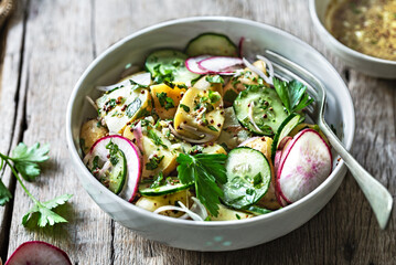 Potato with Cucumber Radish Salad in a bowl