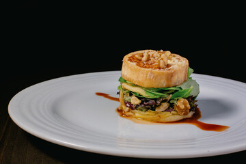 A close-up of a plate with the classic Spanish dish Timbal de Bacalao.  Haute cuisine main course plate.