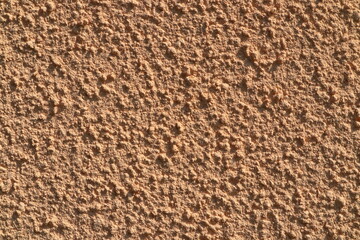 Concrete wall, pink vintage style of cement background paint with small texture details. Copy space for text. Facade outside during the summer in Stockholm, Sweden, Europe.