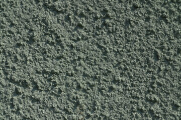Concrete wall, green vintage style of cement background paint with small texture details. Copy space for text. Facade outside during the summer in Stockholm, Sweden, Europe.