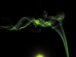 Greenish Smoke presented with light effect created on black background for commercial use.