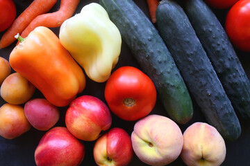 Various colorful summer fruit and vegetable on dark background. Flat lay.