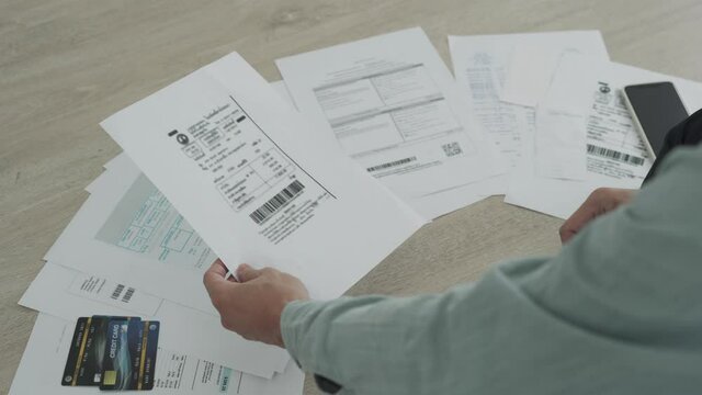 Employee pay bill at home by use mobile phone pay online. The hand uses the phone to scan the QR code to receive a discount from paying electricity bills at the office.