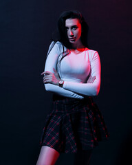 Woman in schoolgirl clothes in neon