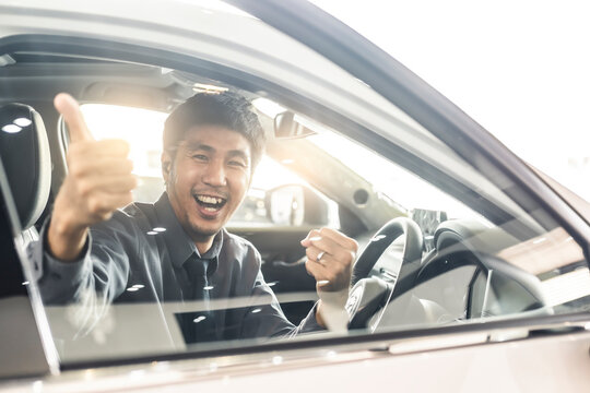 Young Asian man driving car He sometimes smile and thumbs up so happy drive To travel during the outbreak coronavirus covid-19 to male smile image smiling